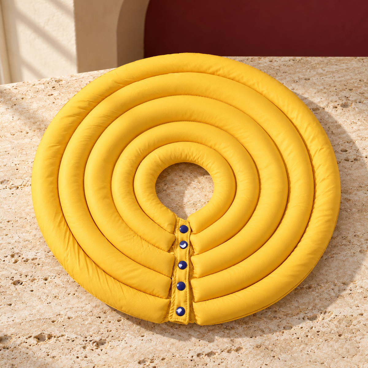Yellow layered recovery cone showing padded rings and fastening