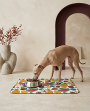 Italian Greyhound eating beside the Iggy Grey food mat