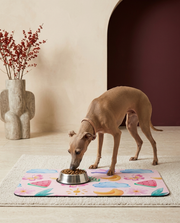 Italian Greyhound eating beside the Iggy Grey food mat