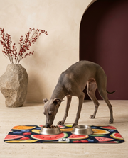 Italian Greyhound eating beside the Iggy Grey food mat