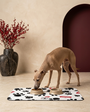 Italian Greyhound eating beside the Iggy Grey food mat