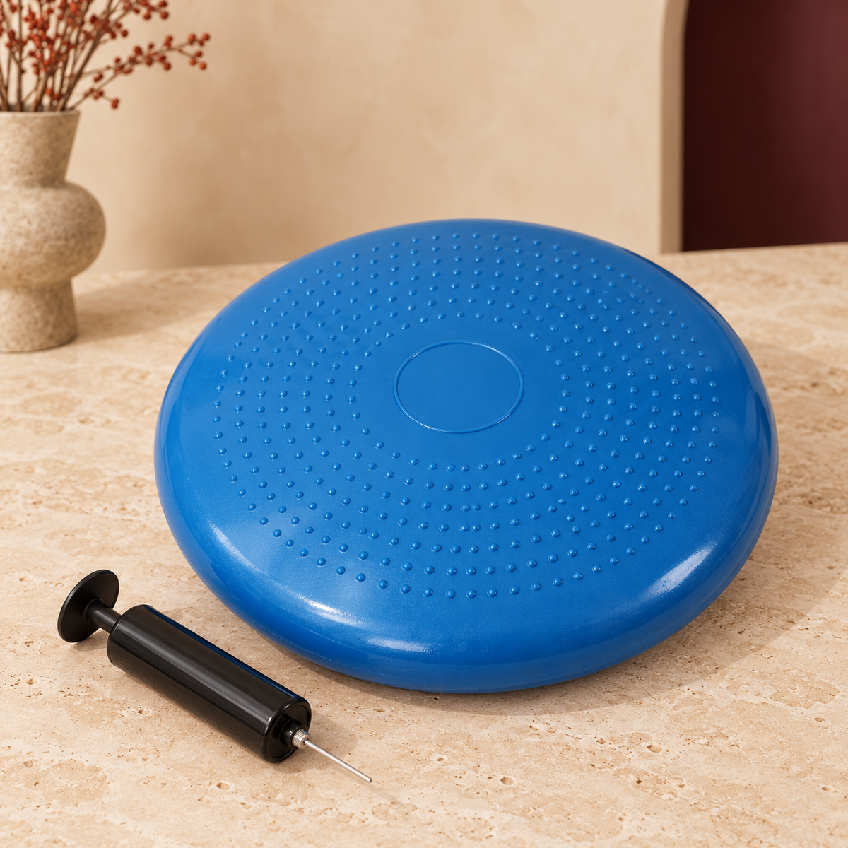 Blue round balance cushion with textured surface and hand pump